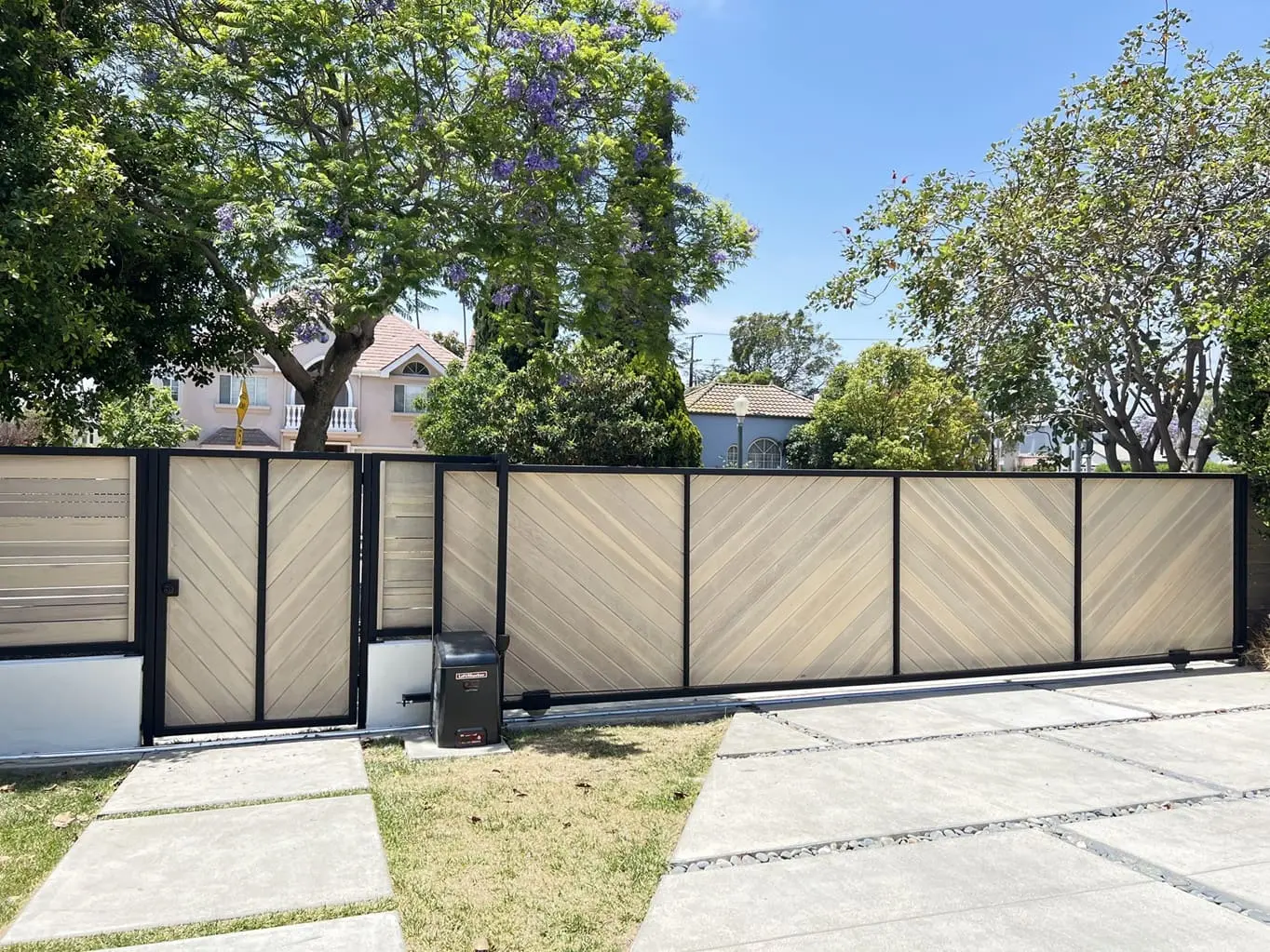 Gate Repair in San Fernando expert fixing an automatic gate motor system near a home entrance